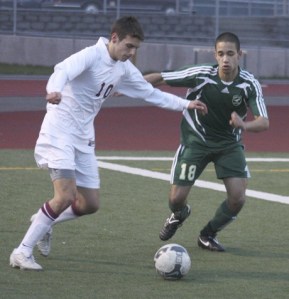 Eastlake senior midfielder Renato Bandiera works against Redmond defender Kris Daniels Tuesday night.