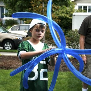 Sam Range twists a balloon octopus.