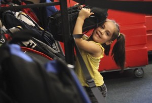 Brandy Serna pulls down a backpack from a shelf at the Issaquah Food and Clothing Bank. The drive filled 1