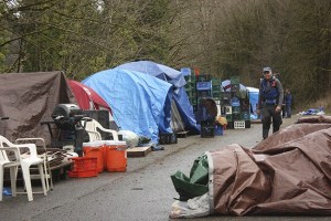 Robb Mitchell of Sammamish hikes past Tent City 4's current location on a gated road north of Tiger Mountain. Tent City 4 relocated there