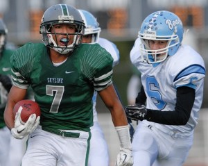 Spartan RB Damian Greene (7) runs past Central Valley defenders for a touchdown during a 4A quarter final playoff game at Skyline on Saturday. Skyline won 52-17.
