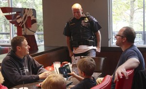 Issaquah Officer Robert Hendrickson takes lunch orders from a party of neighbors from the Renton Highlands the afternoon of Oct. 24.