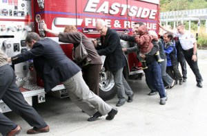 The community along with firefighters push a fire engine into the new Issaquah Fire Station
