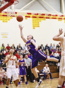 Issaquah junior guard Scott Kellum slices through the Newport defense for a basket on Jan. 3 at Newport High School in Factoria. Kellum scored 13 points in the contest.