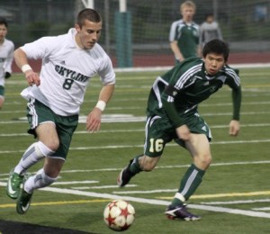 Skyline’s Giancarlo Santoro pushes the ball upfield against Redmond’s Matthew Nease Tuesday night. kevin endejan