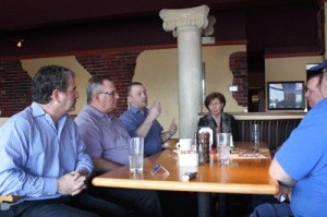 Pine Lake Ale House owner Kevin Gattke discusses business trends and tips on how to succeed in local markets like Sammamish and Issaquah at a Feb. 16 industry roundtable at Lombardi's Restaurant in Issaquah. Left to right: Local Papa Murphys franchise owner Greg Barber and Schwartz Bros. Vice President Michael Carr