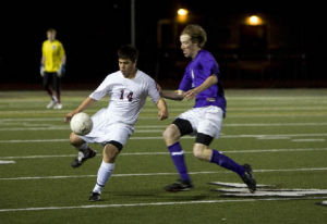 Eastlake junior Patrick Yagi controls the ball while under pressure from a Lake Washington defender Tuesday night.