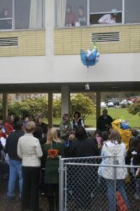 Eggs away! The egg containers are dropped out of a second story window. The object of the project was to create a container that would keep the raw egg from breaking during the 15-foot drop.