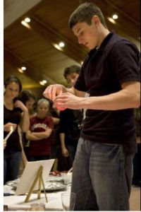 Eastlake Junior Blair Workman lights a candle with many other well wishers at a vigil on June 4.
