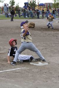 Eastlake all star Austin Hooker slides safely into third base as a Lake Stevens fielder bobbles the ball.
