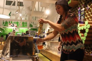 Daniel Nash/staff photo Ashley Belline of Hilliard’s Beer pours a cold one at the Beat the Winter Brews Fest in February. The Greater Issaquah Chamber of Commerce will add a second summer festival July 29.