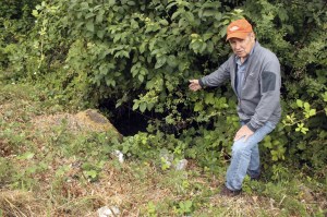 Megan Campbell/staff photoWally Pereyra stands at the Zackuse Creek culvert under East Lake Sammamish Parkway Southeast.