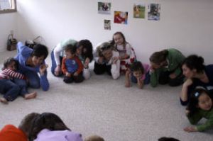 The class pounds their “coude” (elbow) on the floor during a song about body parts.