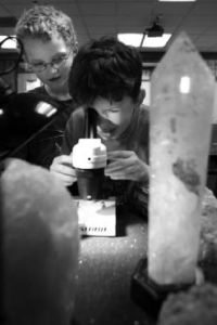 Sean Kinnear checks out some crystals through the lens of a microscope as Cale Smith looks on during a recent science fair at Margaret Mead Elementary School in Sammamish. Both students are first-graders.
