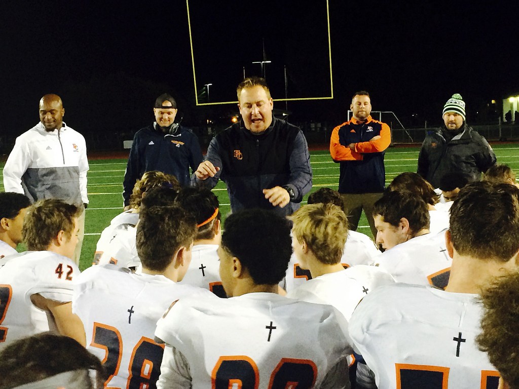 Eastside Catholic Crusaders head coach Jeremy Thielbahr, center, talks with his team following their 39-21 win against the Timberline Blazers on Nov. 11 at South Sound Stadium in Lacey.                                Shaun Scott, staff photo