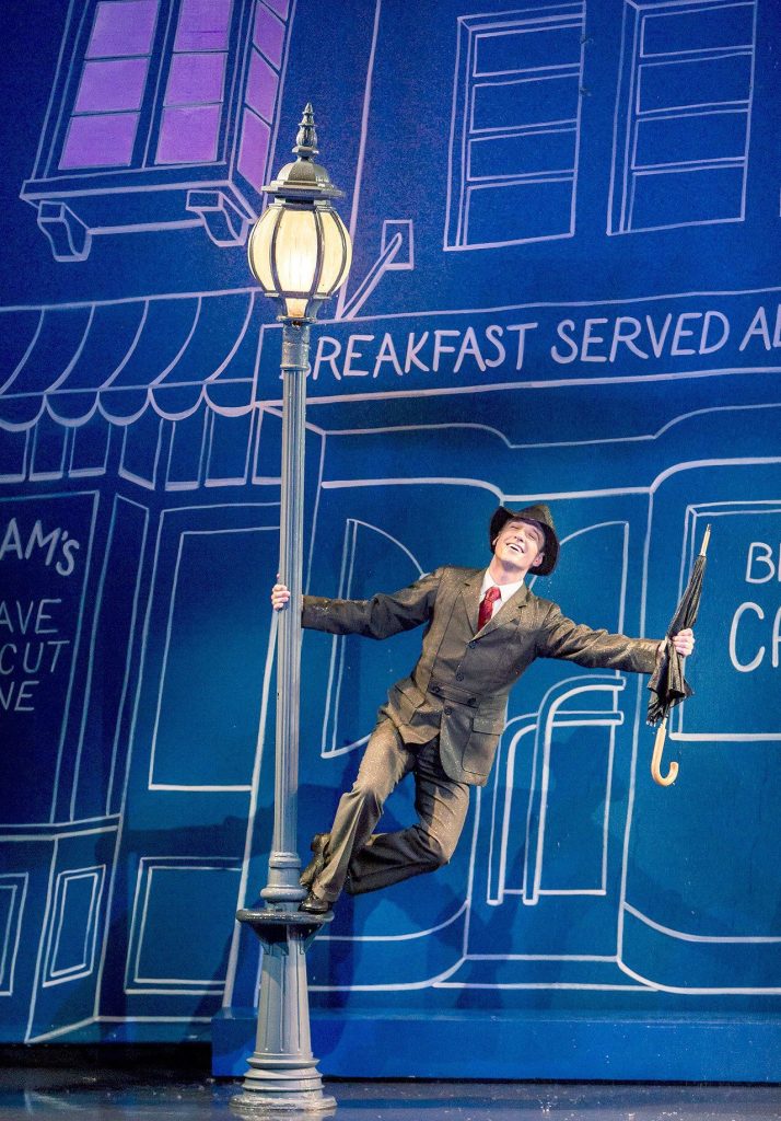 Village recreates the movie&rsquo;s most iconic scene with real rain. Photo courtesy of Village Theatre