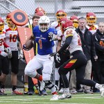 Photo courtesy of Rick Edelman/Rick Edelman Photography                                Eastside Catholic Crusaders senior Hunter Bryant delivers a devastating stiff arm to Braves defensive back Dillon Crawford in the Class 3A semifinals on Nov. 26 at Pop Keeney Stadium in Bothell. The Kamiakin Braves defeated the Eastside Catholic Crusaders 30-27 to advance to the Class 3A state championship game.