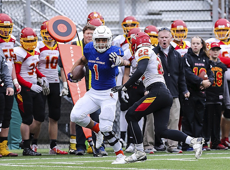 Photo courtesy of Rick Edelman/Rick Edelman Photography                                Eastside Catholic Crusaders senior Hunter Bryant delivers a devastating stiff arm to Braves defensive back Dillon Crawford in the Class 3A semifinals on Nov. 26 at Pop Keeney Stadium in Bothell. The Kamiakin Braves defeated the Eastside Catholic Crusaders 30-27 to advance to the Class 3A state championship game.