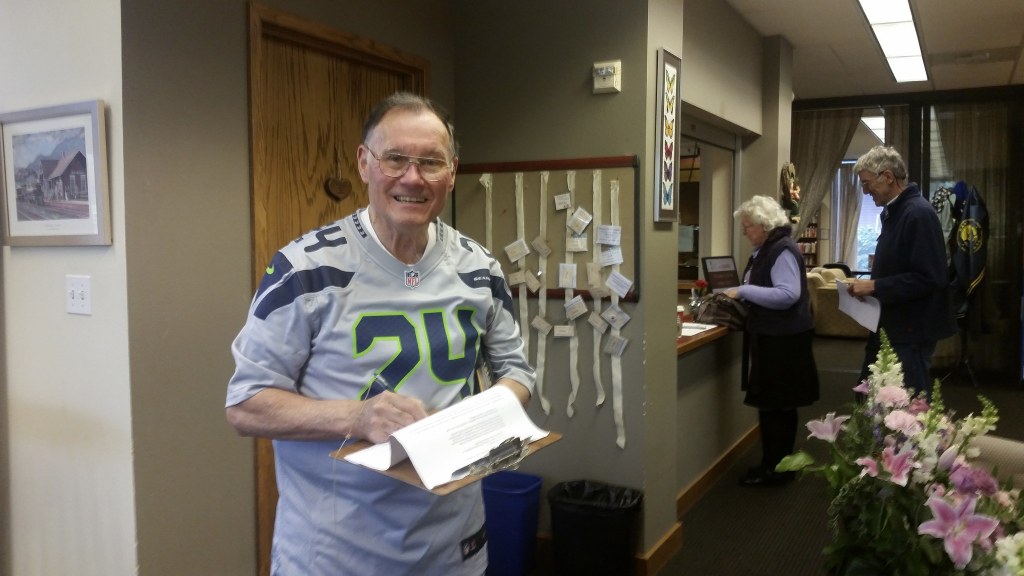 As a member of the senior center, David Waggoner signs a petition requesting a special meeting of seniors. Nicole Jennings/staff photo