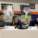Olivia Jacobsen (University of Notre Dame-lacrosse), Sophia Cerino (University of California at Berkeley-lacrosse) and Jackson Bandow (Yale University-baseball) signed letters of intent with their respective collegiate choices during a signing day ceremony on Nov. 9 at Eastside Catholic School in Sammamish.                                Photo courtesy of Alexandra Gunnoe/Eastside Catholic School