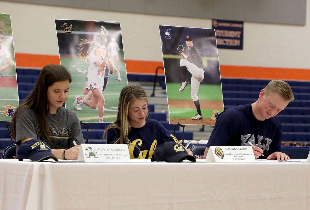 Olivia Jacobsen (University of Notre Dame-lacrosse), Sophia Cerino (University of California at Berkeley-lacrosse) and Jackson Bandow (Yale University-baseball) signed letters of intent with their respective collegiate choices during a signing day ceremony on Nov. 9 at Eastside Catholic School in Sammamish.                                Photo courtesy of Alexandra Gunnoe/Eastside Catholic School