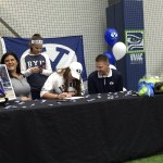 Issaquah Eagles senior Morgan Bevell, center, signs a letter of intent to play softball at Brigham Young University on Nov. 14 at the Virginia Mason Athletic Center in Renton.                                Shaun Scott, staff photo
