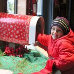 6-year-old Liam Meyer mails his wish list to Santa at the zoo&rsquo;s post office. Liam would like a piano for Christmas so he can learn to play like his dad. Nicole Jennings/staff photo