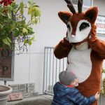 Dylan Meyer, 4, gives a warm greeting to a reindeer at the zoo&rsquo;s entrance. Dylan visited the zoo on the second day of the festival, Dec. 2, with his parents and older brother Liam. Nicole Jennings/staff photo