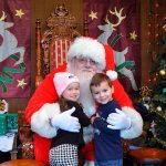 Makena Golden and Parker Roycroft, both 3, climb up on Santa&rsquo;s lap to whisper their holiday wishes. The two are big fans of the Cougar Mountain Zoo and are zoo members, visiting almost every weekend during warmer months. Santa is at the zoo daily through Dec. 23. Photo courtesy of Cari McKinstry