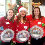 Megan Matuszewski, Cameryn Mirafuentes and Rachel Arata of the Springhill Suites Marriott won the prize for having the ugliest festive sweaters. They said that they made their snowglobe costumes themselves in only a couple of hours. Nicole Jennings/staff photo