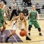 Issaquah Eagles junior Maya Witherspoon, center, controls the ball as Woodinville players Madison Dubois and Nikki Zaback converge on her. The Falcons defeated the Eagles 61-43 on Dec. 12 at Issaquah High School.                                Photo courtesy of Rick Edelman/Rick Edelman Photography