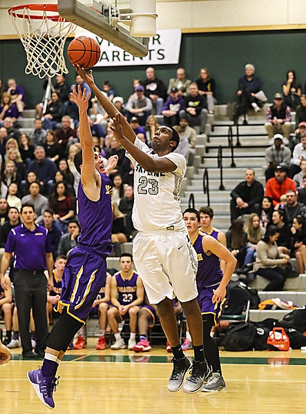 Photo courtesy of Rick Edelman/Rick Edelman Photography                                Skyline junior forward Ashish Manda attacks the basket for a bucket against the Issaquah Eagles on Dec. 16 in Sammamish. The Spartans defeated the Eagles 63-55 in a battle between rival squads.