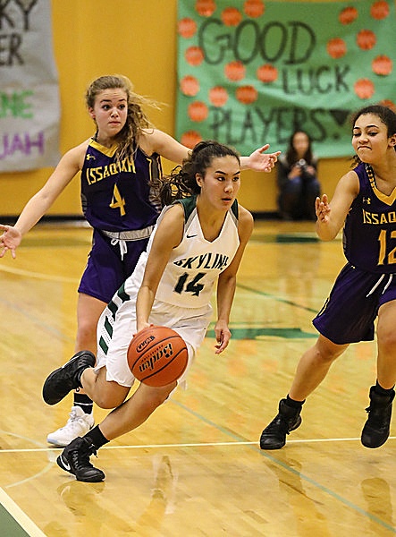 Photo courtesy of Rick Edelman/Rick Edelman Photography                                 Skyline Spartans junior guard Julia Mitchell drives to the basket against the Issaquah Eagles. Mitchell hit 10 free throws in the third quarter. Skyline defeated Issaquah 63-45 on Dec. 16 in Sammamish.