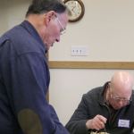 David Waggoner presents IVS Board President Craig Hansen with a petition signed by 30 senior center members to send remaining IVS funds to the Issaquah Food and Clothing Bank. Nicole Jennings/staff photo