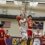 Photo courtesy of Don Borin/Stop Action Photography                                Issaquah senior Tanner Davis, left, takes the ball strong to the basket while being chased by Newport junior Marcus Fukutomi, right, on Jan. 13 at Issaquah High School.
