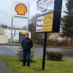 Sergio Barajas stands in front of the monument sign that the city has not allowed him to fill in yet. He said that the Shell station&rsquo;s monument sign behind him is twice the height of the sign in front of his own business. Nicole Jennings/staff photo