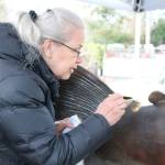 Artist Sara Johani carefully stains the affected area with liver of sulfur to match the rest of the fish. Nicole Jennings/staff photo