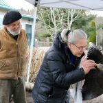 Tom Jay, left, who sculpted the bronze statue in 1996, watches as his wife and business partner Sara Johani, right, paints over the spot where an unknown vandal made a cut with a saw. Nicole Jennings/staff photo