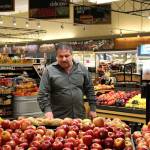 Nicole Jennings/staff photo                                Jimmy Kathawa organizes the fresh fruit in his shop. He and his wife redid the produce area upon taking over the business.
