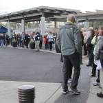 A line of shoppers stretches from the entrance of Metropolitan Market to across the parking lot and around the corner down 228th Avenue Southeast (Joe Livarchik/staff photo).