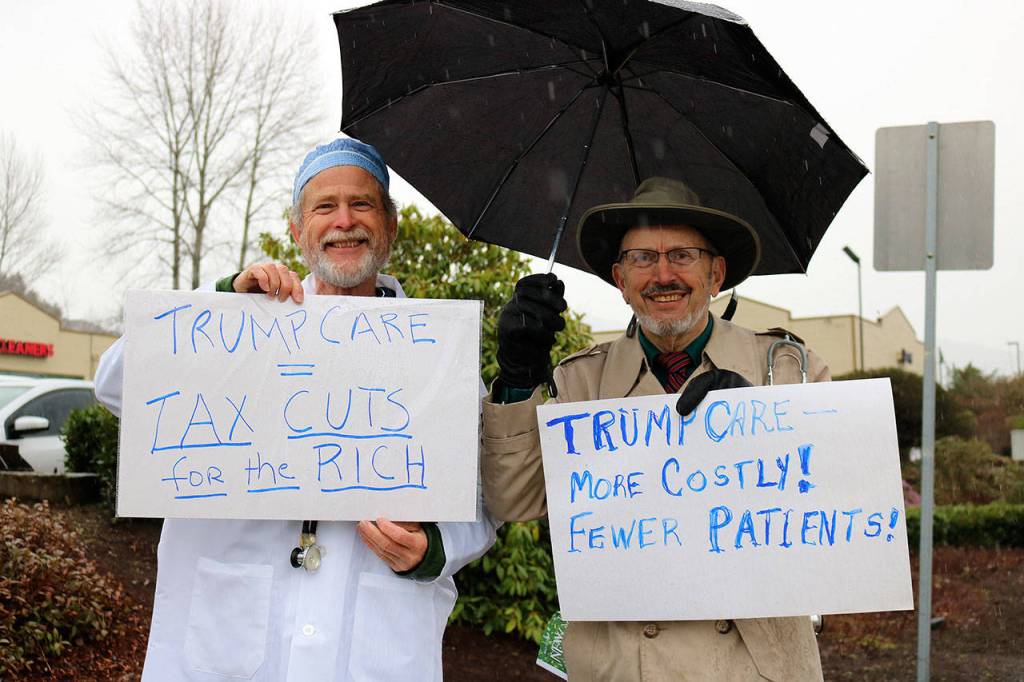 Nicole Jennings/staff photo                                Left, Jim Bernthal of Seattle borrowed the lab coat and scrubs of his friend Tom Harly, right, of Leavenworth, who is a retired doctor.