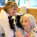 Truitt the Sheltie made friends with Issaquah Nursing and Rehabilitation Center resident Maxine Bice, right, when he and his owner Laurie Wilson, left, visited the center on March 16. Nicole Jennings/staff photo
