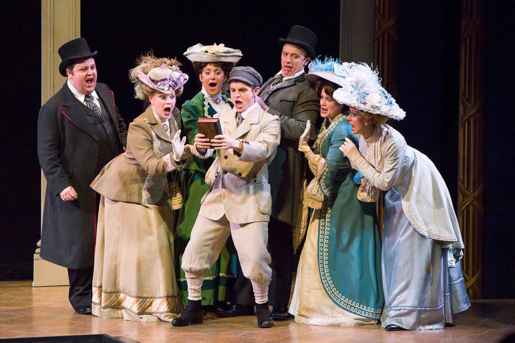 The costumes of the show exhibit the class distinctions, with the wealthy wearing large, feathered hats and elegant gowns. Photo courtesy of Village Theatre