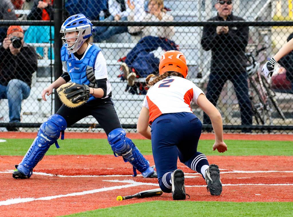 Photo courtesy of Rick Edelman/Rick Edelman Photography                                Eastside Catholic Crusaders sophomore Nicole Moe safely into home-plate against the Seattle Prep Panthers. The Crusaders earned a 9-7 win against the Panthers on March 31 in Sammamish.