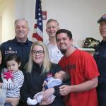 Back row, from left, Eastside Fire and Rescue Lieutenant Daryl Butler, Bellevue Fire Paramedic Todd Metter, Eastside Firefighter Mark Leroy. Front row, from left, mom Debora Ascheman holding daughter Kayla, three, 911 dispatcher Jenna Mapes holding baby Benjamin and dad Ryan Ascheman. Nicole Jennings/staff photo