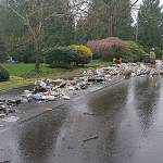Recycling materials were dumped in the roadway after a recycling truck driver noticed a fire had broken out in the back of his truck. Police believe the fire was caused by a butane torch that had been placed in a recycling bin (photos courtesy of the Sammamish Police Department&rsquo;s Facebook page).