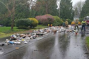 Recycling truck dumps haul of materials after fire breaks out in rear of vehicle