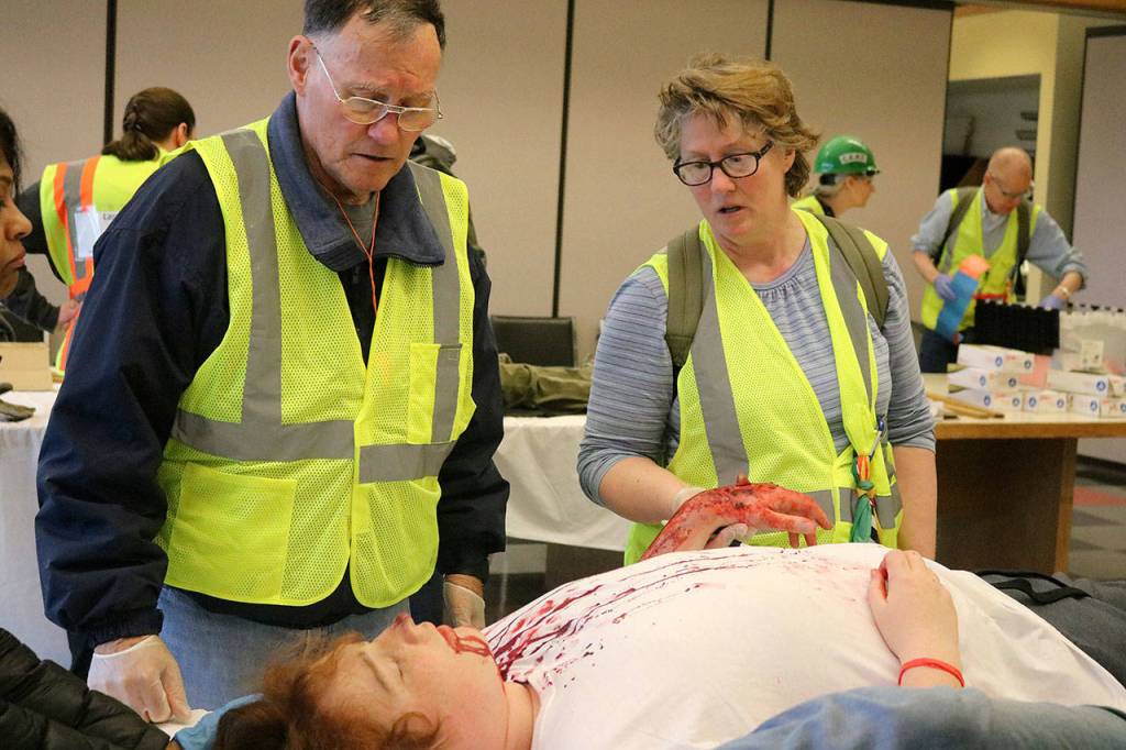 Even when confronted with realistic and sometimes grotesque-looking injuries, CERT students had to keep a cool head and figure out how best to help the victims. Nicole Jennings/staff photo