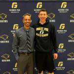 Photo courtesy of Stephanie Wilson                                Issaquah Eagles boys basketball player Brent Wilson (right) committed to the George Fox University men&rsquo;s basketball program on April 24. Wilson, who plays in the post, led the KingCo 4A Conference in blocked shots per game during the 2016-17 season. George Fox University is coached by Maco Hamilton (left).