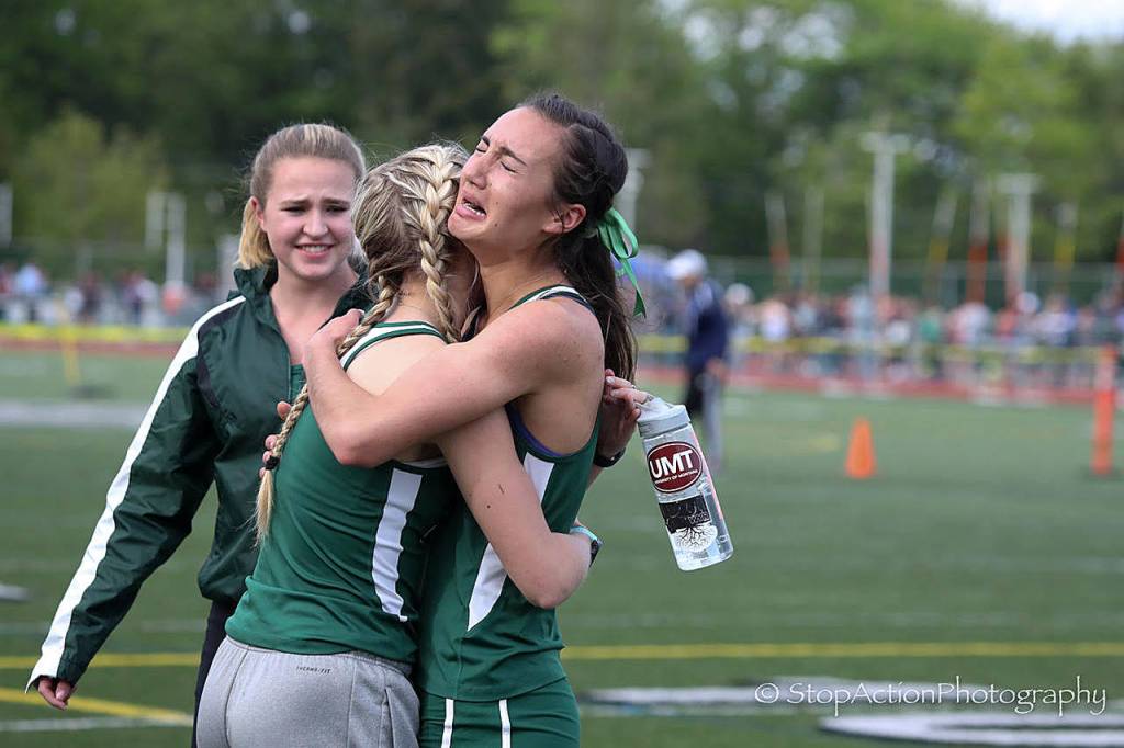 Photo courtesy of Don Borin/Stop Action Photography                                Skyline Spartans junior Geneva Schlepp, right, experienced tears of joy after capturing first place in the girls 1600-meter run at the KingCo 4A meet on May 10, clocking a time of 4:56.07. Schlepp broke the Skyline school record which was set by Alexis Daugherty&rsquo;s time of 5:00.75 in 2014.
